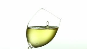 Drop of White Wine falling into Glass, against White Background,